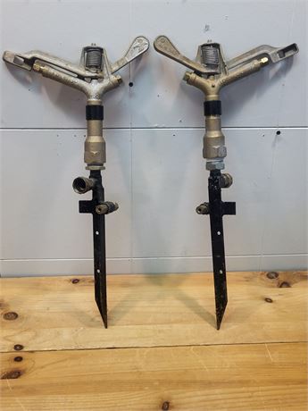 Pair of Vintage Rain Bird Brass Impact Sprinklers on Metal Ground Spikes